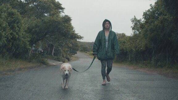 一个在大雨中遛狗的女人