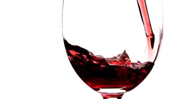 红酒倒进白色背景的玻璃杯中