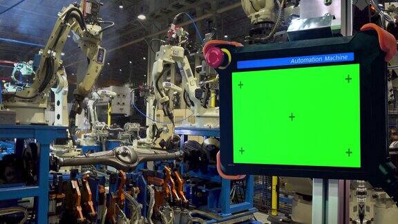 工业机器人正在焊接的汽车零件在工厂与运动控制器空白绿屏