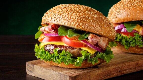 放大两个新鲜的自制美味汉堡在绿色背景快餐概念