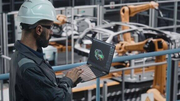汽车工厂工程师在工作制服使用笔记本电脑与数字3DCAD车辆蓝图男汽车工业生产设备专家从事汽车生产