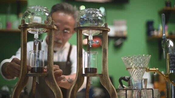 亚洲华人高级男咖啡师在咖啡店准备冰滴咖啡