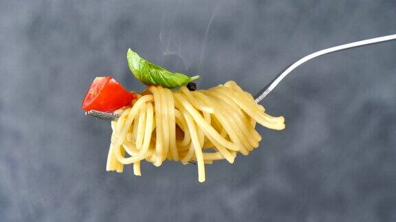 叉子上有意大利面番茄和罗勒烟