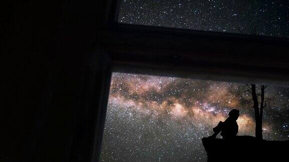 透过窗户看到孤独的女孩和银河