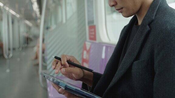 男子在火车上使用数码平板电脑