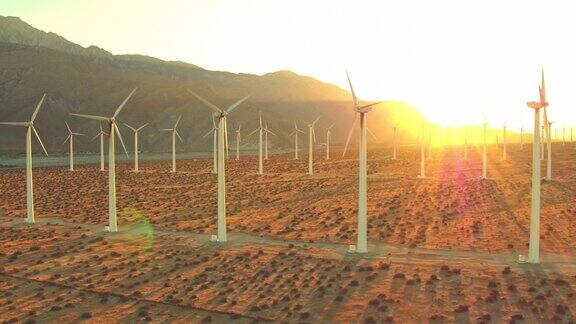 鸟瞰图风力涡轮机在日落旋转清洁可持续的可再生能源