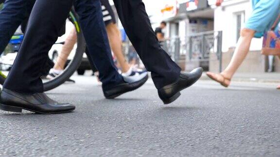 两个不认识的商人的脚走在城市的街道上商人们一起通勤上班自信的人正在去办公室的路上同事的腿都走了慢动作特写侧视图