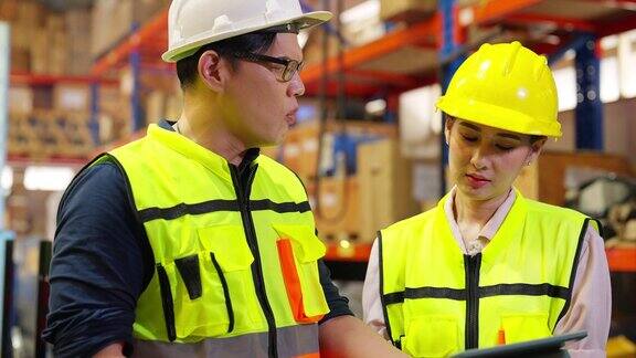 4K亚洲男女工程师在建筑工地操作机械臂