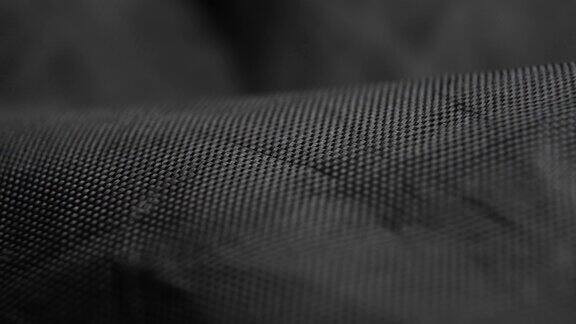 卷曲的黑色合成纤维织物纹理折痕