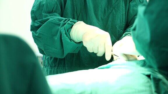 多民族外科手术组穿着防护服在医院手术室进行手术医疗队在现代手术室进行手术