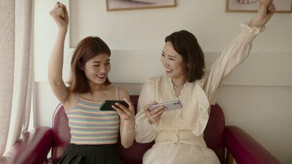 年轻的亚洲女性玩手机游戏