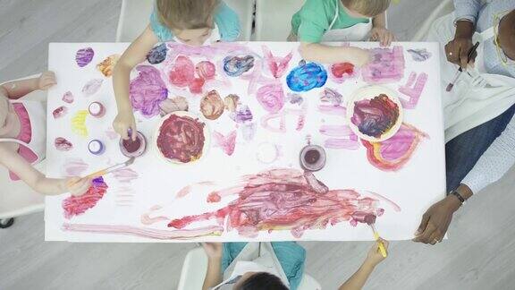 在儿童艺术和手工艺课上桌子完全被油漆覆盖