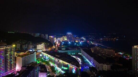 夜晚照亮三亚著名的大东海海滩小镇屋顶全景4k时间推移海南岛中国