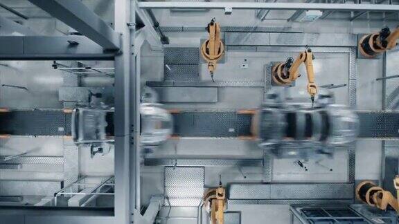 空中汽车工厂3D概念:自动化机器人手臂装配线制造高科技绿色能源电动汽车建筑焊接工业生产输送机TopViewTime-LapseLoop