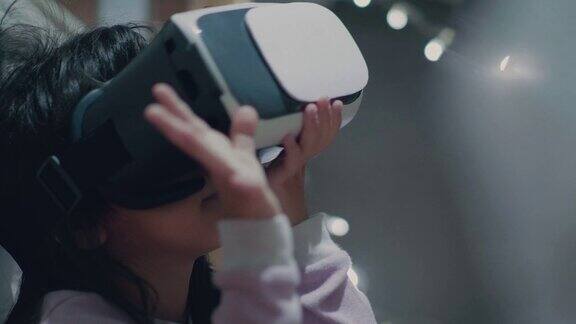 亚洲小女孩在虚拟现实头盔在家