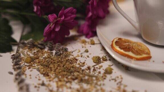 近距离观察桌子上的陶瓷茶杯桌子上有草药蜂蜜罐鲜花