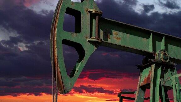 采油抽油机在日落的天空下工作