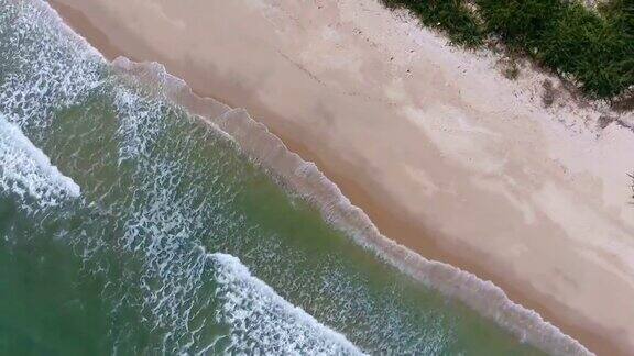 头顶拍摄的热带海洋和海滩与波浪打破在美丽的一天航拍视频