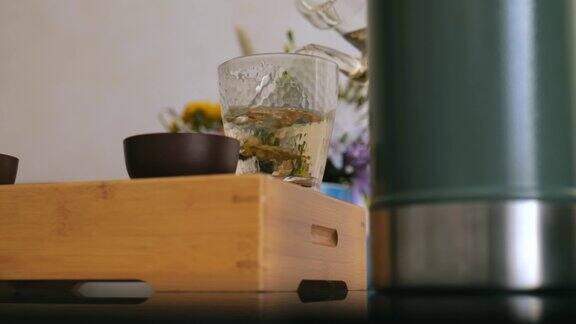 爱喝茶的人将煮好的白茶从茶壶中倒入特制的茶玻璃器皿中