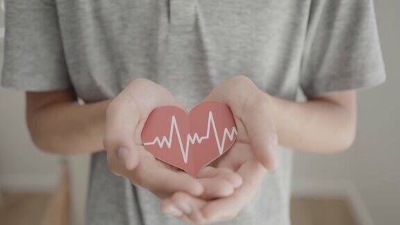 手握红心带心电保健爱与家庭观念世界卫生日世界高血压日祈祷观念