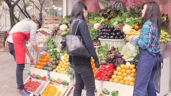 在市场上卖蔬菜的亚洲女售货员
