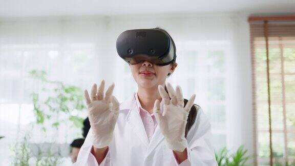 年轻的亚洲科学家穿着实验服戴着VR技术眼镜观察分子结构在现代实验室从事生物技术研究的女性研究员生物植物概念的研究与发展