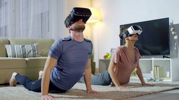 戴着VR眼镜的男人和女人在练瑜伽