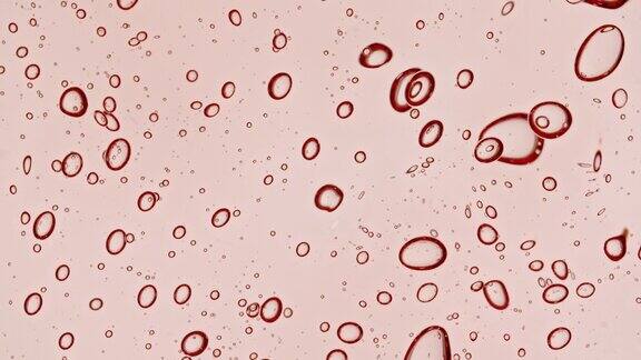 粉红色透明化妆品凝胶液与分子气泡流动微距镜头