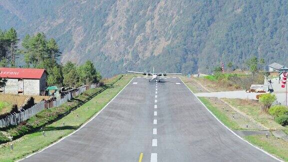 飞机降落在山区小镇的灰色跑道上到达机场