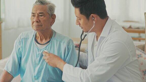 医生对他的老年病人进行家访在家使用听诊器