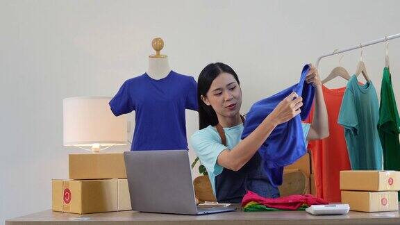 亚洲美女在家通过社交媒体直播卖衣服