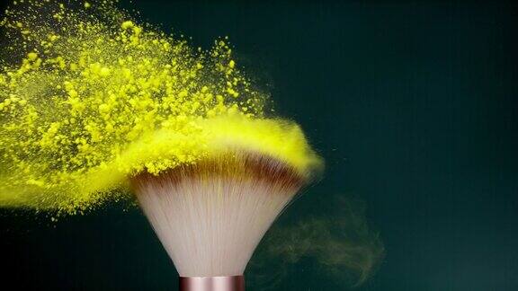 化妆刷与黄色粉末爆炸在绿色背景超级慢动作