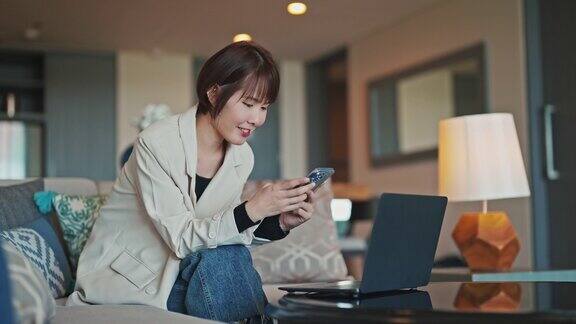 亚洲女商人在酒店使用智能手机