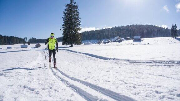 越野滑雪者在田园诗般的冬季风景滑雪轨道上