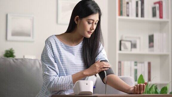 年轻女子使用自动血压计