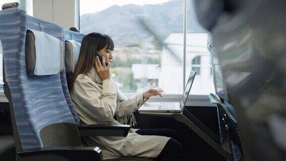 4K亚洲女性在火车上用笔记本电脑工作打手机