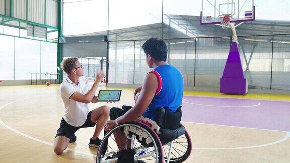 轮椅篮球运动员在球场上与教练会面