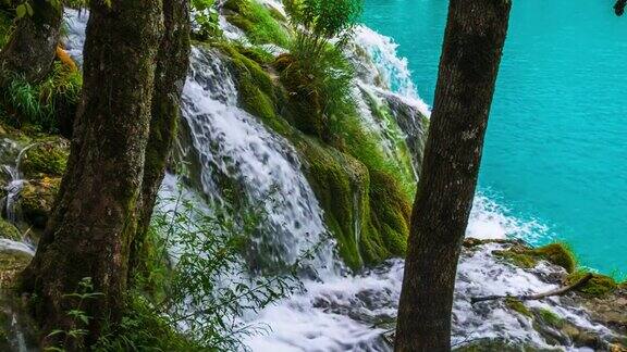 宁静的自然景色与森林瀑布和绿松石湖-慢镜头