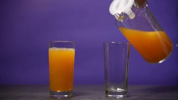 把橙汁倒进玻璃杯里