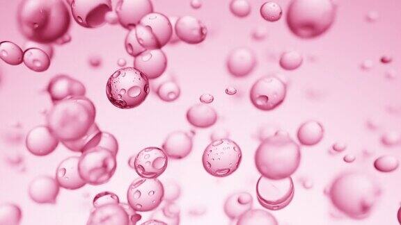 粉红色背景上升起的液体气泡