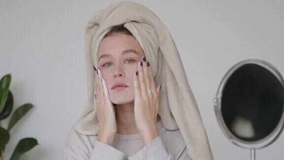 一名女子正在用有机泡沫肥皂洗面奶洗脸女孩正在清洁面部皮肤做按摩动作美容、水疗、养生、健康护肤理念