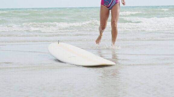 一个亚洲女人在暑假独自在海滩冲浪户外生活方式和极限活动
