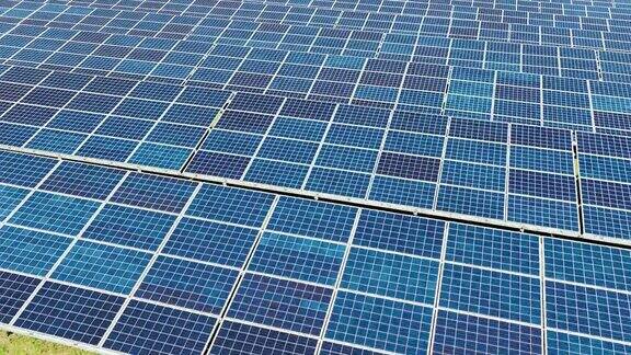 太阳能农场的太阳能光伏板产生可再生电力的航拍视频
