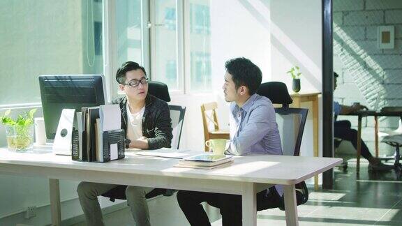两个亚洲企业家在办公室里讨论生意