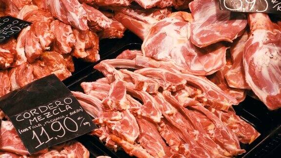 在LaBoqueria市场的一个柜台里托盘里有价格标签的新鲜生肉巴塞罗那西班牙