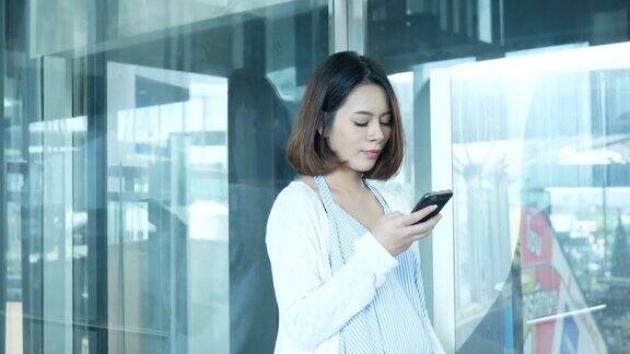 孕妇在电梯里使用智能手机