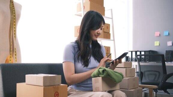 创业小企业主中小企业女企业家在收单箱上工作核对网上订单准备打包箱子卖给客户中小企业网上创业的想法