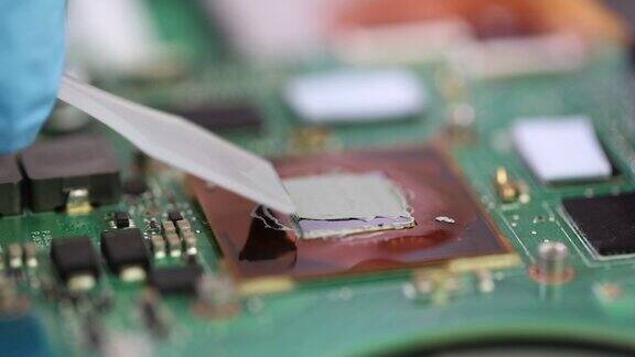 修理工在微芯片视频卡上应用热粘贴特写4k电影慢动作