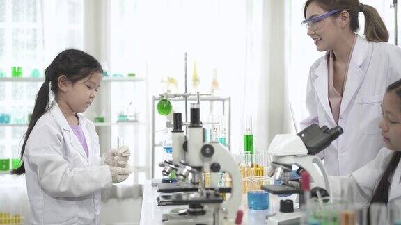 科学实验室里的亚洲孩子们正在试管里学习为他们的科学项目做有趣的实验