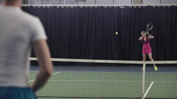 一对年轻情侣在打网球